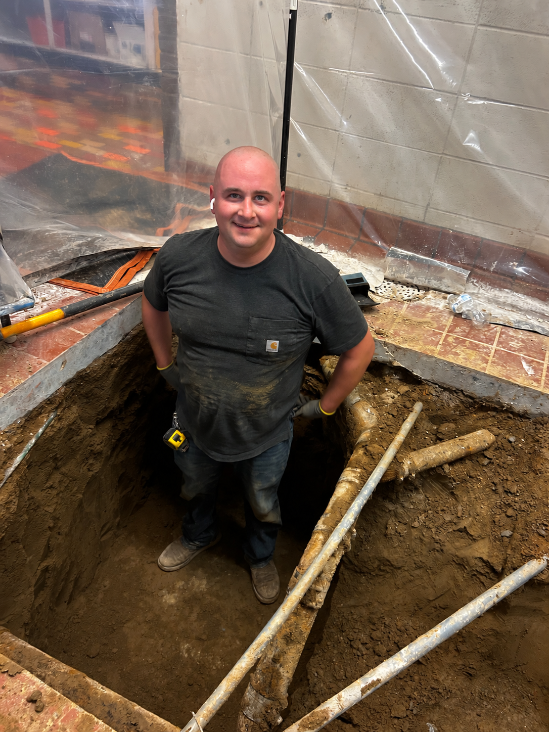 Eric Hanson working in a plumbing trench
